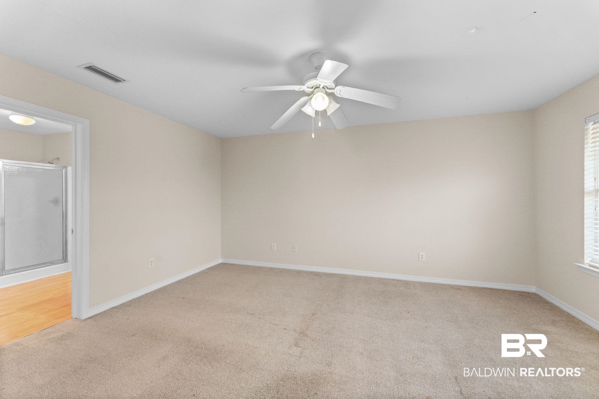 4009 Kendallbrook Loop Foley, AL 36535 - Photo 14 of 28 Empty room featuring light carpet and a ceiling fan