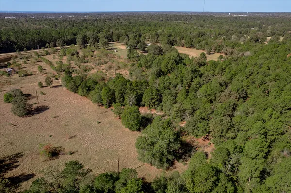 an aerial view of a houses with a yard