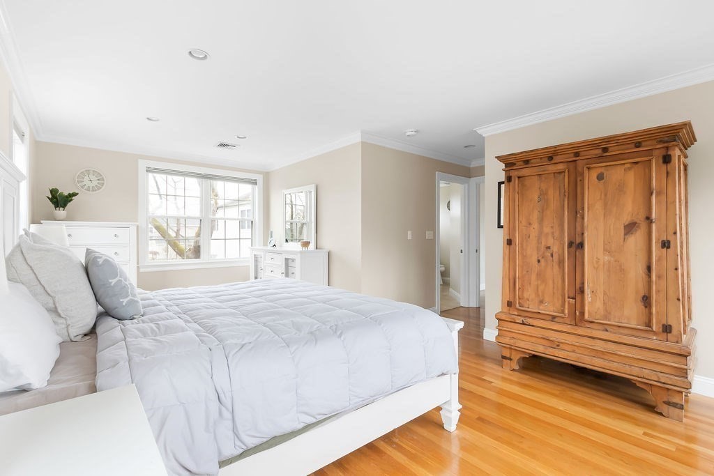 7 Maple Place Needham, MA 02492 - Photo 11 of 26 a spacious bedroom with a bed and wooden floor