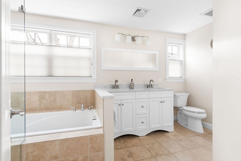 7 Maple Place Needham, MA 02492 - Photo 12 of 26 a bathroom with a granite countertop sink toilet and bathtub