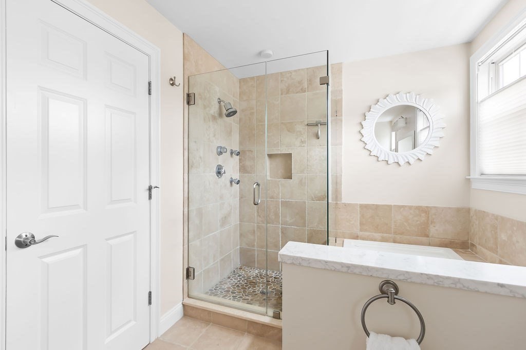 7 Maple Place Needham, MA 02492 - Photo 13 of 26 a bathroom with a granite countertop shower sink and mirror