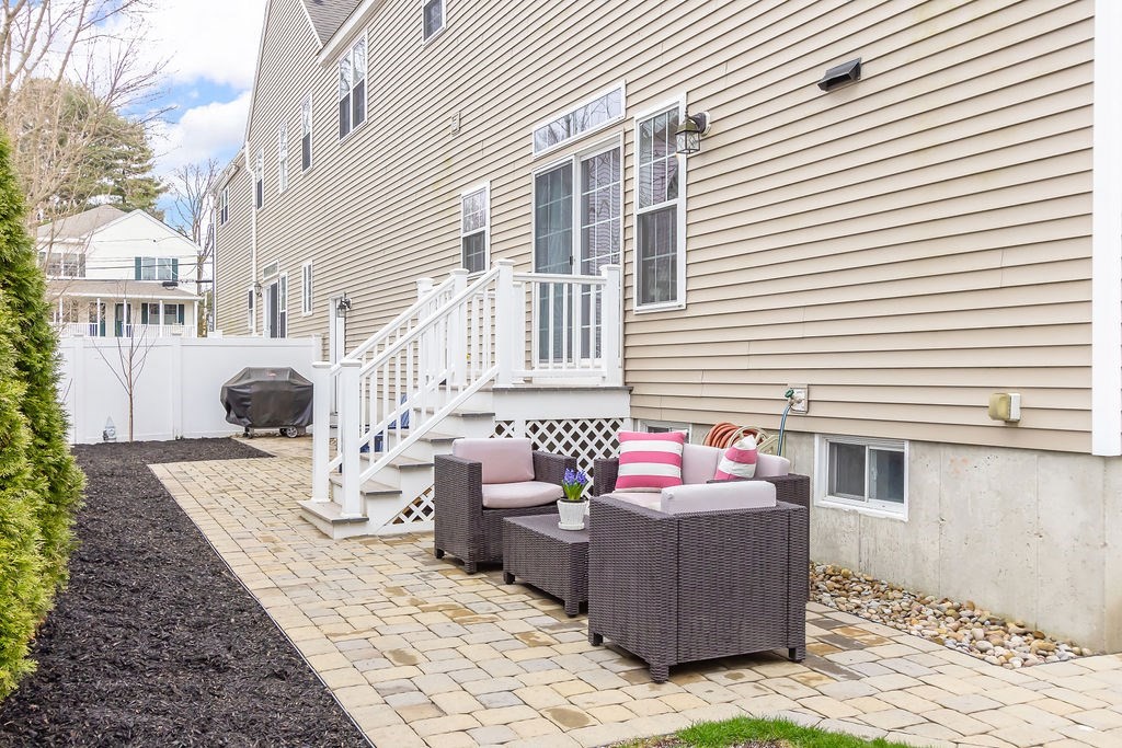 7 Maple Place Needham, MA 02492 - Photo 24 of 26 a front view of a house with yard