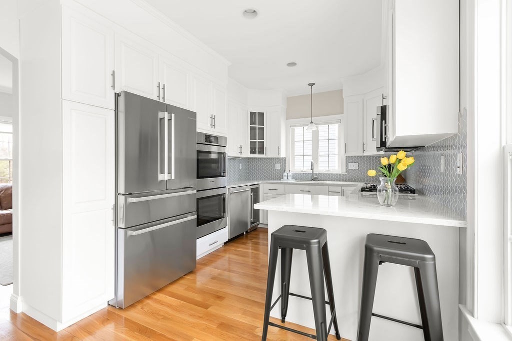 7 Maple Place Needham, MA 02492 - Photo 5 of 26 a kitchen with refrigerator and stove