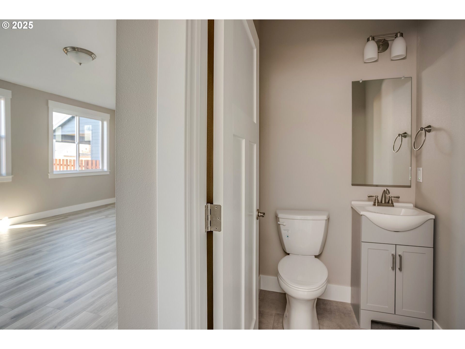 790 17th Avenue Seaside, OR 97138 - Photo 11 of 29 a bathroom with a toilet a sink and mirror