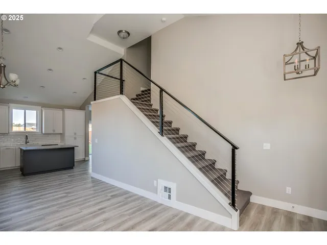 a kitchen with stainless steel appliances a sink a stove a refrigerator and cabinets