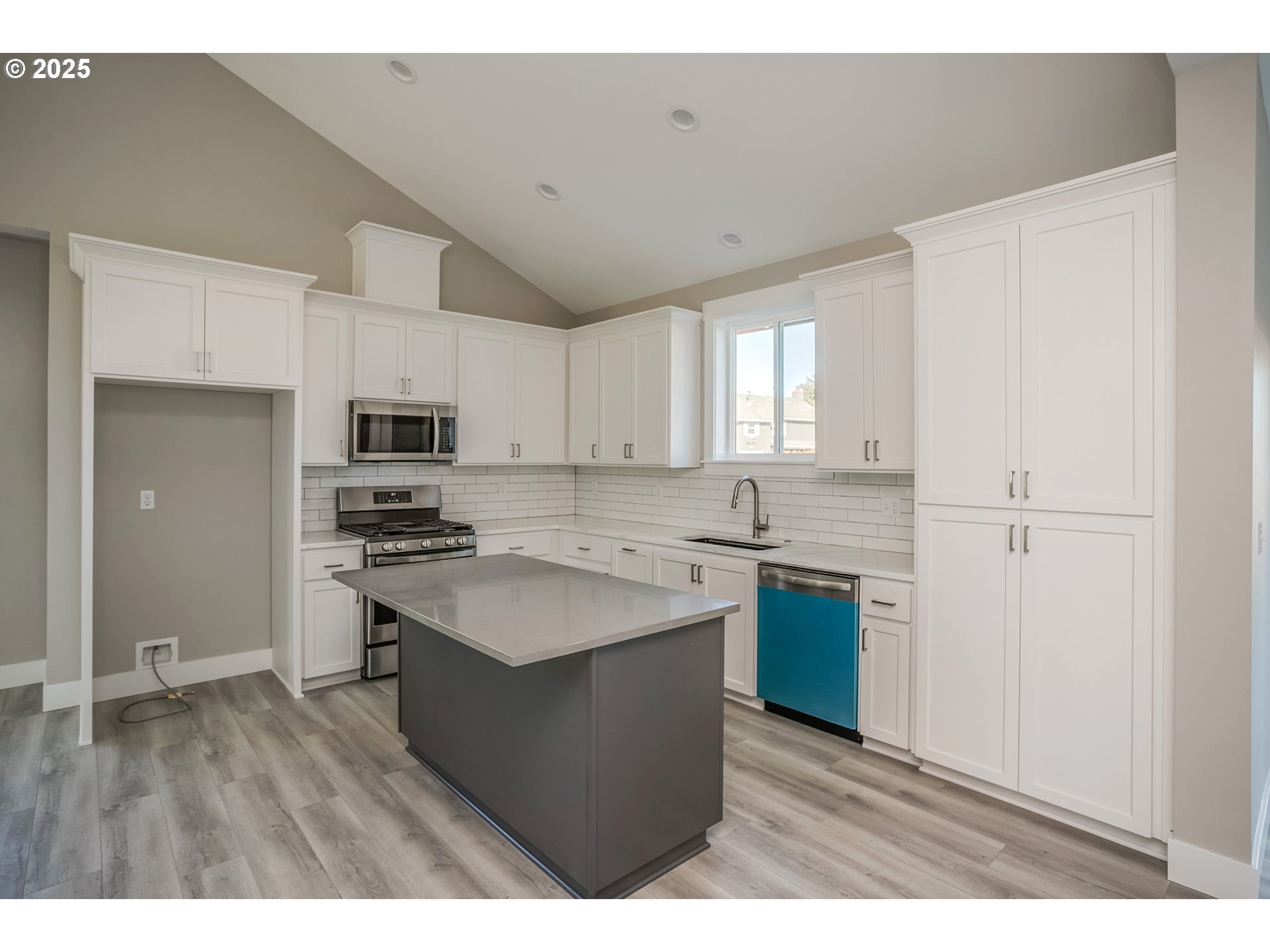 790 17th Avenue Seaside, OR 97138 - Photo 8 of 29 a kitchen with stainless steel appliances a sink a stove a refrigerator and cabinets