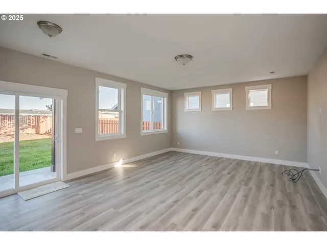 a open kitchen with cabinets wooden floor and stainless steel appliances