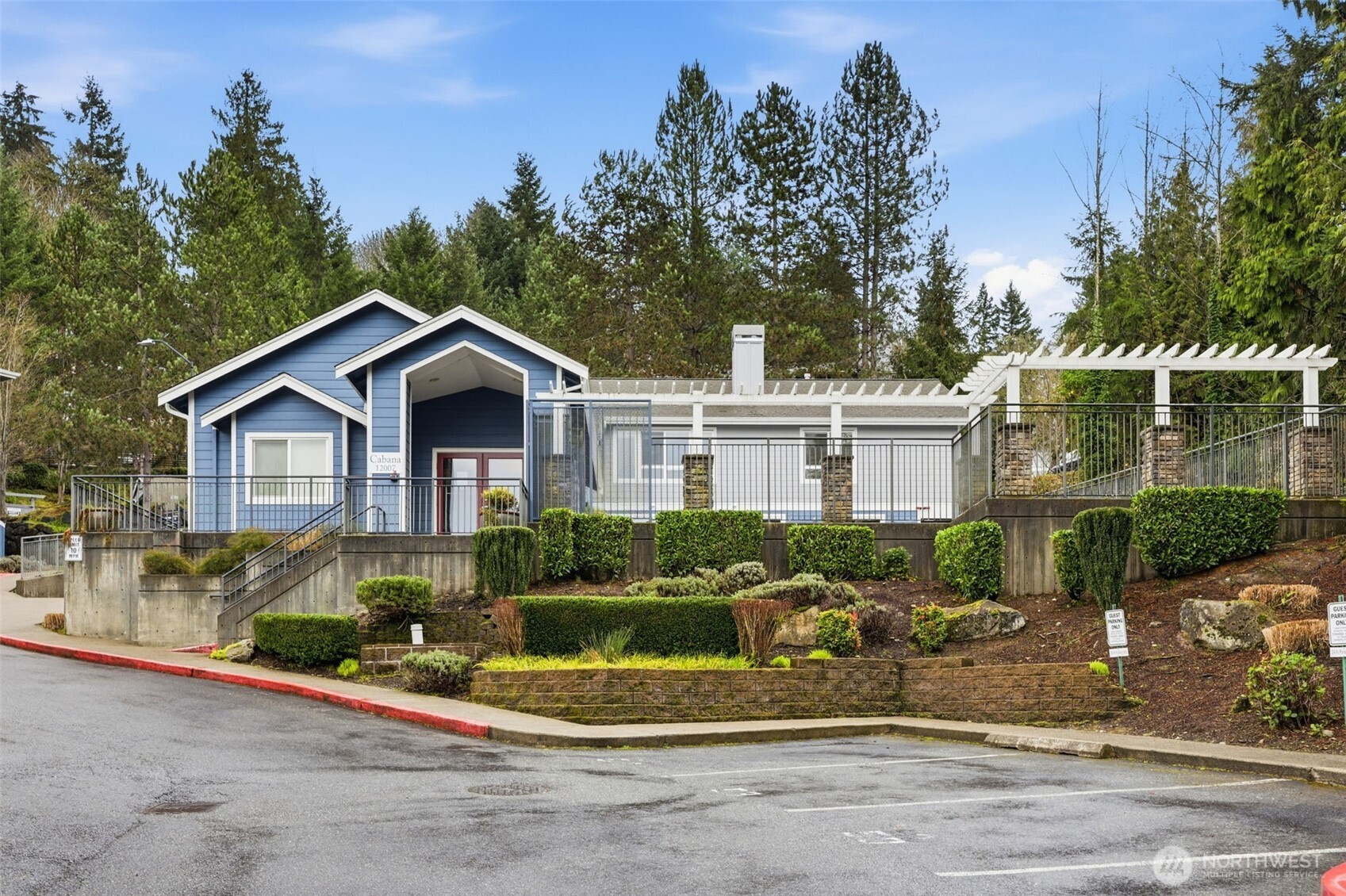3914 243rd Place Southeast, Unit L301 Bothell, WA 98021 - Photo 14 of 19 a front view of a house with a yard and potted plants