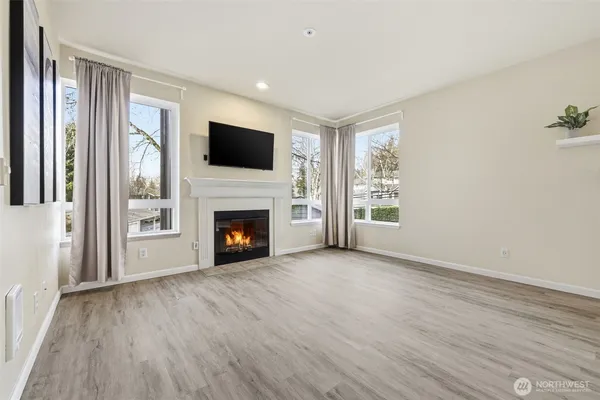 a view of a livingroom with a fireplace wooden floor and window