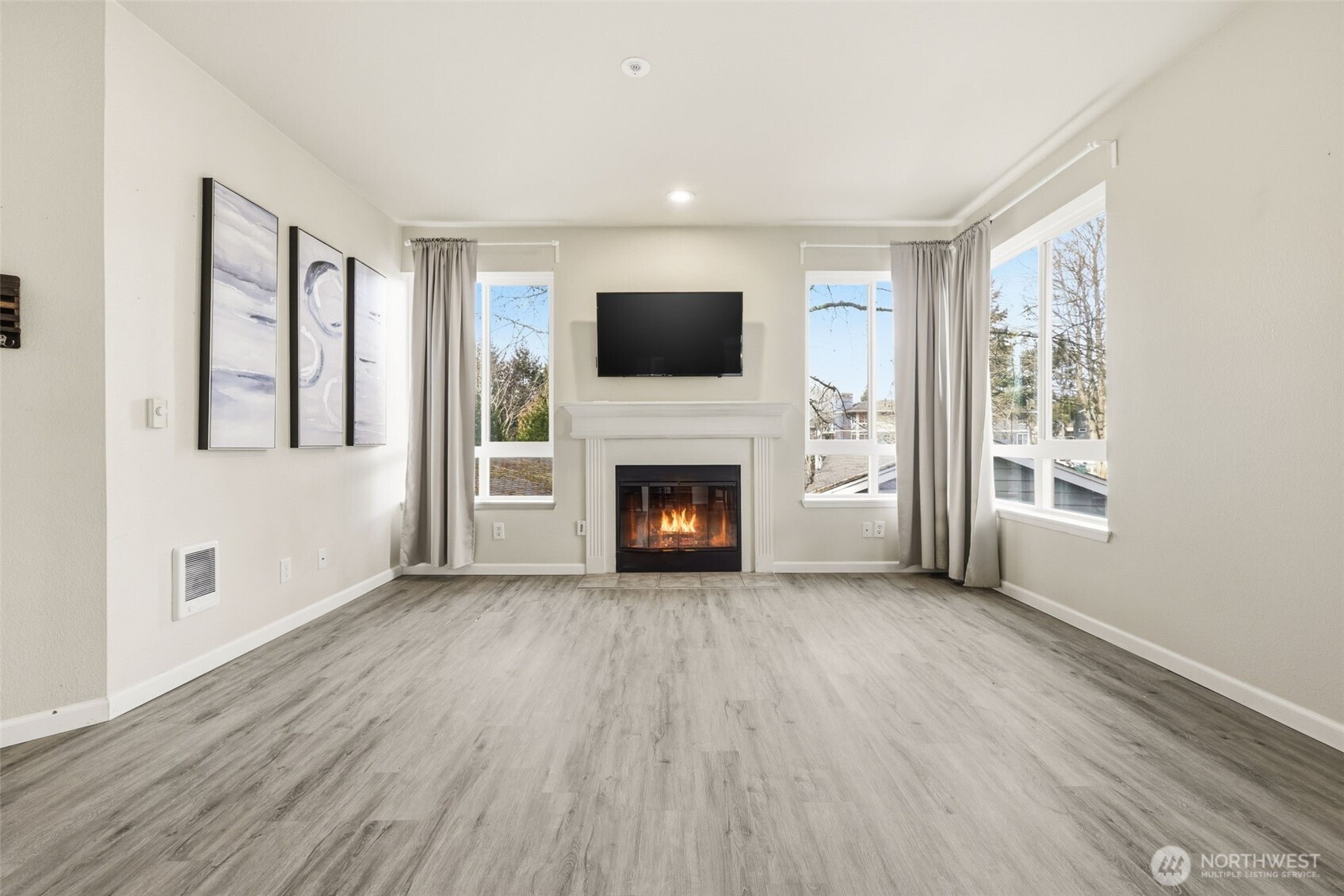 3914 243rd Place Southeast, Unit L301 Bothell, WA 98021 - Photo 5 of 19 a view of an empty room with wooden floor fireplace and a window