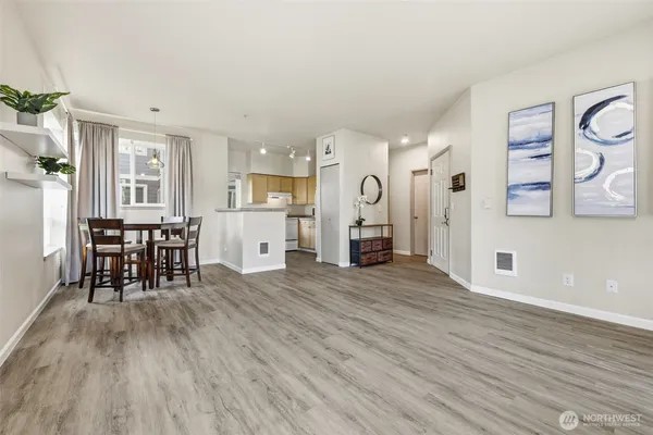 a view of a kitchen with furniture and wooden floor