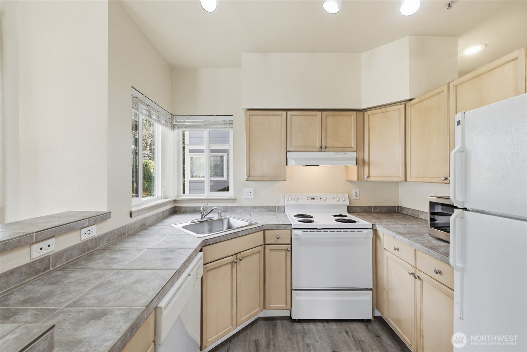 3914 243rd Place Southeast, Unit L301 Bothell, WA 98021 - Photo 7 of 19 a kitchen that has a sink cabinets counter space and appliances