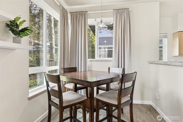 a view of a dining room with furniture and a potted plant