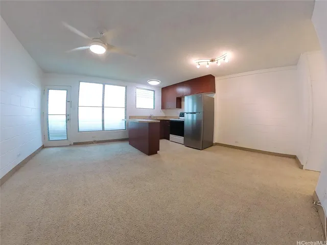 a view of a kitchen with furniture and windows