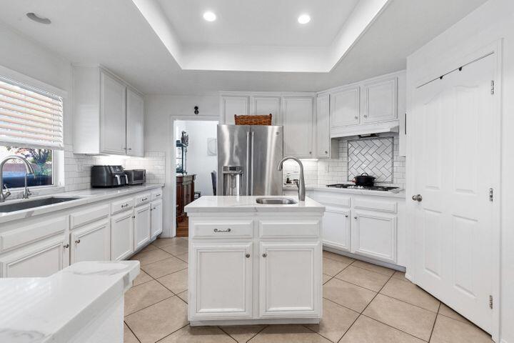 4008 Dee Dee Court Lancaster, CA 93536 - Photo 6 of 8 a kitchen with white cabinets and white appliances