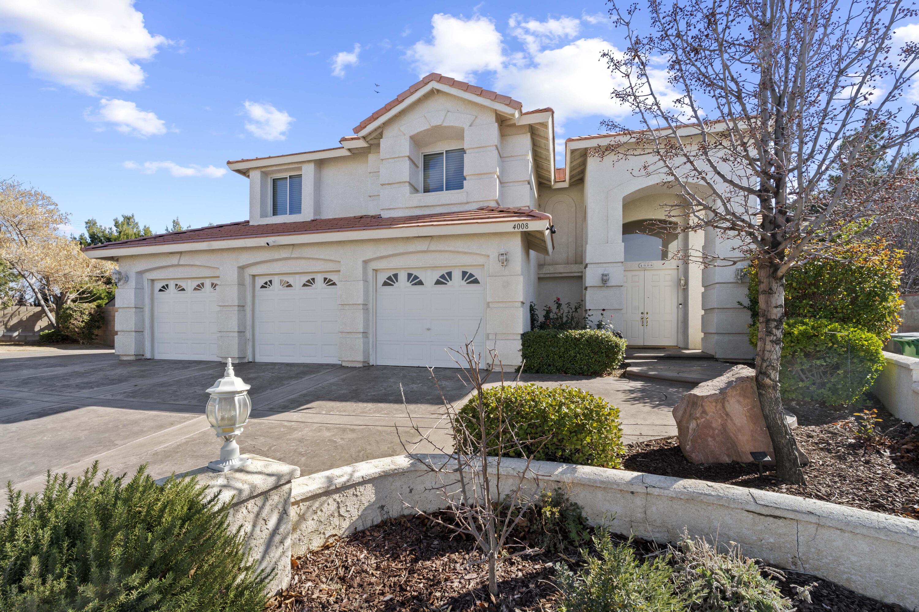4008 Dee Dee Court Lancaster, CA 93536 - Photo 8 of 8 a front view of a house with garden