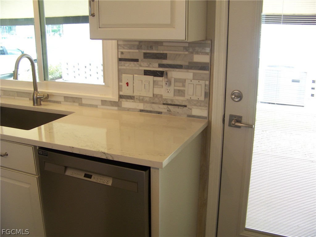 15550 Burnt Store Road, Unit 202 Punta Gorda, FL 33955 - Photo 15 of 50 a kitchen with a sink and a window