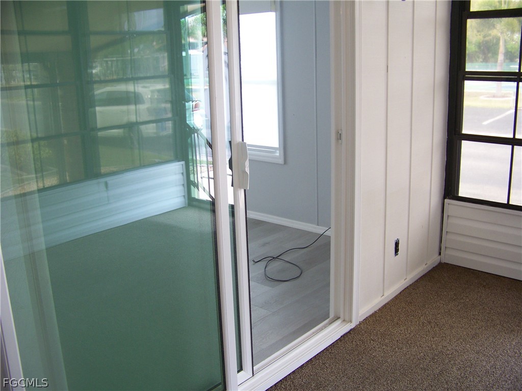 15550 Burnt Store Road, Unit 202 Punta Gorda, FL 33955 - Photo 27 of 50 a bathroom with a glass shower door