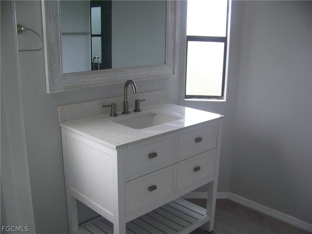 15550 Burnt Store Road, Unit 202 Punta Gorda, FL 33955 - Photo 37 of 50 a bathroom with a sink and a mirror