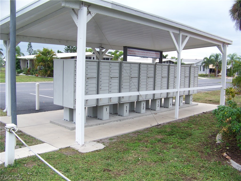 15550 Burnt Store Road, Unit 202 Punta Gorda, FL 33955 - Photo 44 of 50 a view of a patio with table and chairs under an umbrella