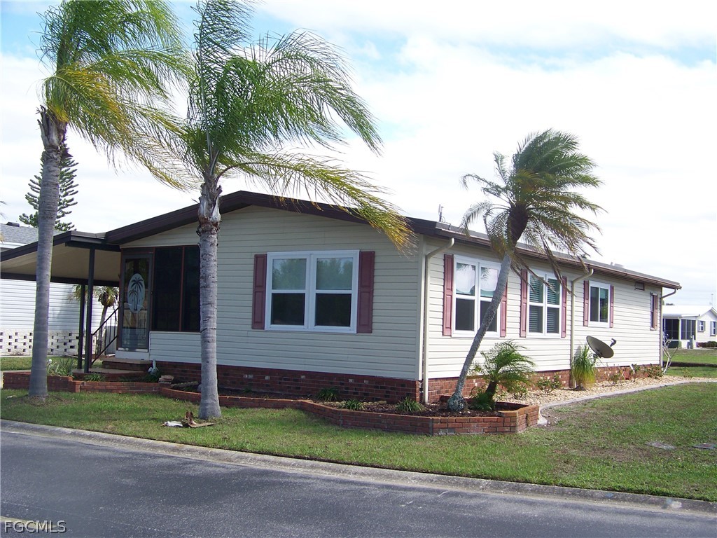 15550 Burnt Store Road, Unit 202 Punta Gorda, FL 33955 - Photo 5 of 50 a house that has a palm tree in front of it