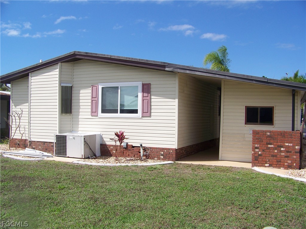 15550 Burnt Store Road, Unit 202 Punta Gorda, FL 33955 - Photo 7 of 50 a backyard of a house with table and chairs