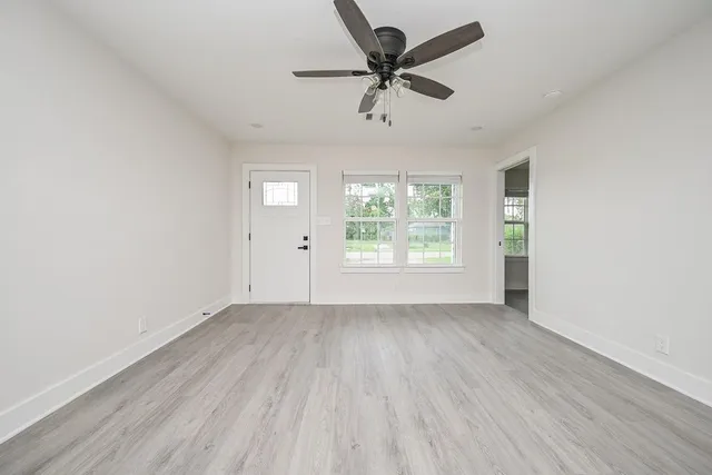 wooden floor in an empty room with a window