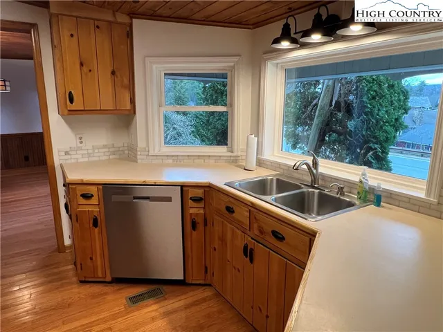 a kitchen with stainless steel appliances granite countertop a sink and a stove
