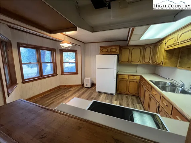 a kitchen with a sink and refrigerator