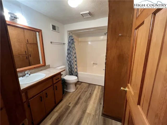a bathroom with a double vanity sink toilet and shower