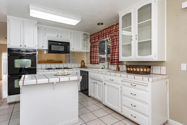 a kitchen with stainless steel appliances granite countertop a stove and a microwave