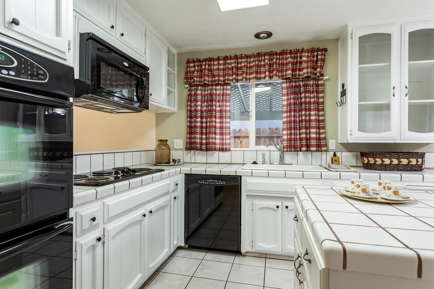 1505 Bandera Lane Modesto, CA 95355 - Photo 13 of 35 a kitchen with stainless steel appliances granite countertop a stove and a microwave
