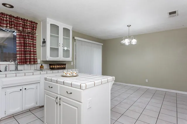 a kitchen with a sink stove and white cabinets