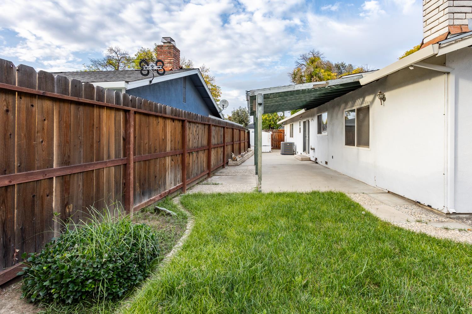 1505 Bandera Lane Modesto, CA 95355 - Photo 19 of 35 a view of backyard with potted plants and wooden fence