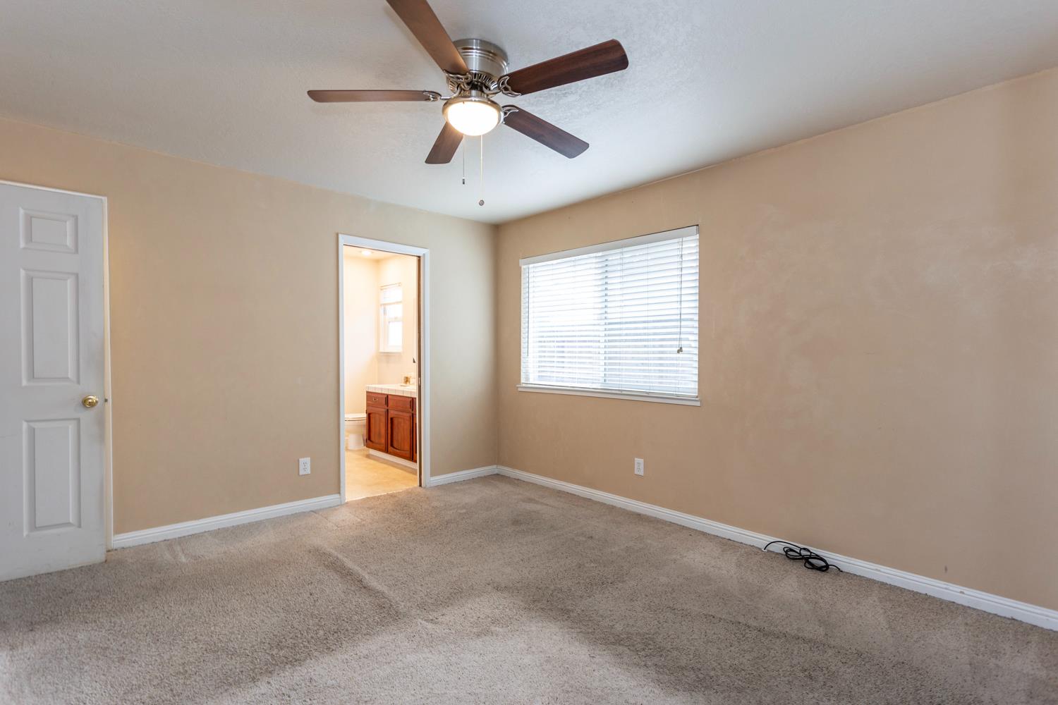 1505 Bandera Lane Modesto, CA 95355 - Photo 25 of 35 an empty room with ceiling fan and windows