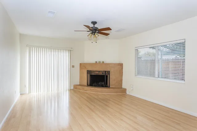 a view of a livingroom with a fireplace and window