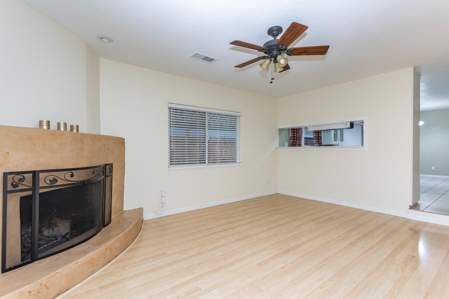 1505 Bandera Lane Modesto, CA 95355 - Photo 5 of 35 a view of empty room with wooden floor and fireplace