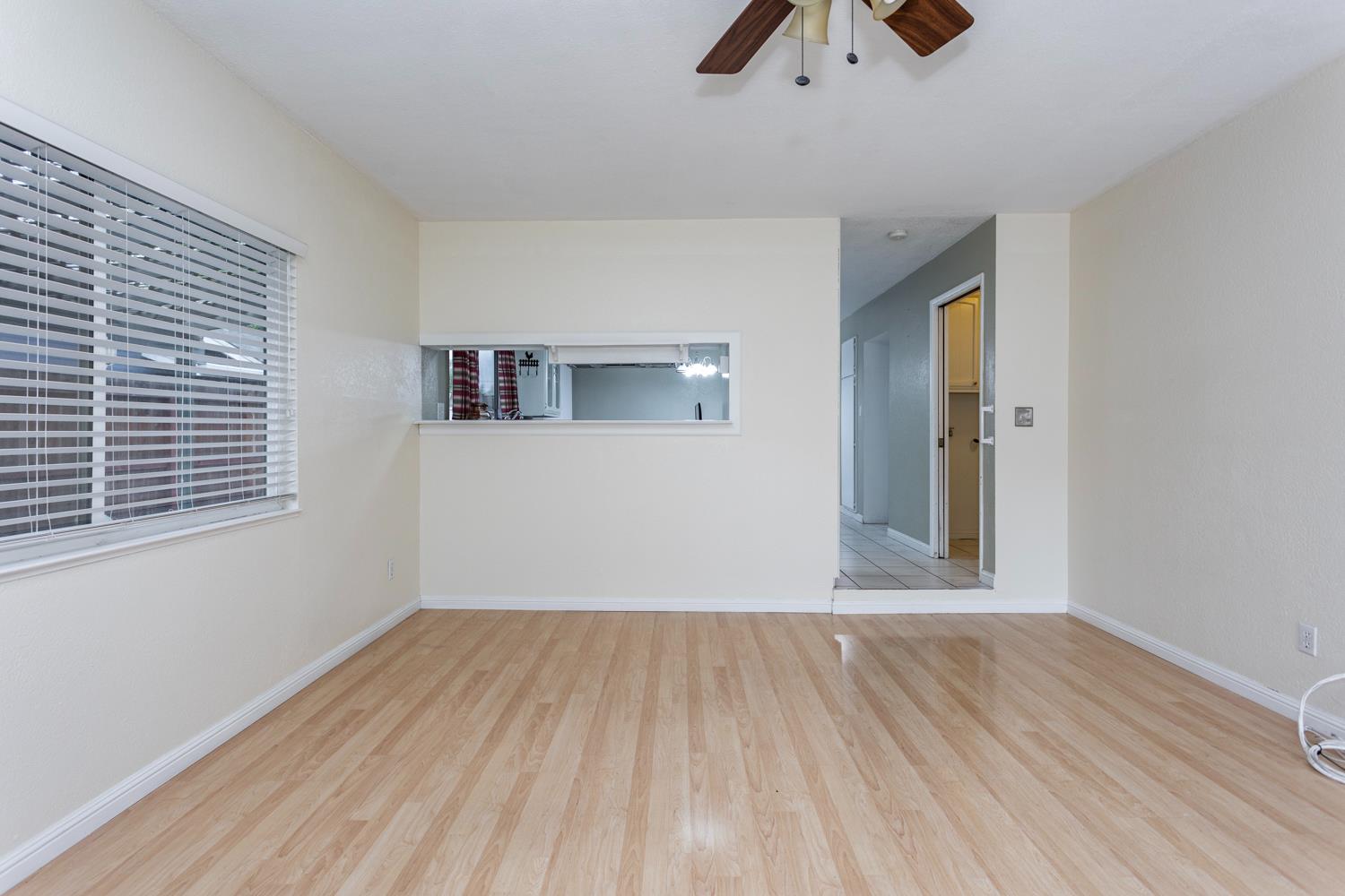 1505 Bandera Lane Modesto, CA 95355 - Photo 6 of 35 a view of an empty room with wooden floor and a window