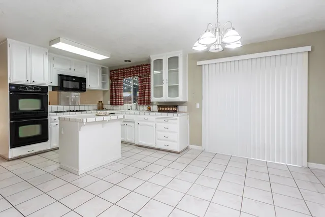 a kitchen with stainless steel appliances a sink and cabinets