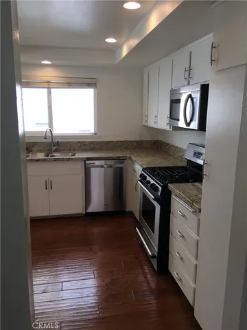 a kitchen with granite countertop stainless steel appliances and sink