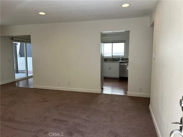 an empty room with closet and wooden shelves