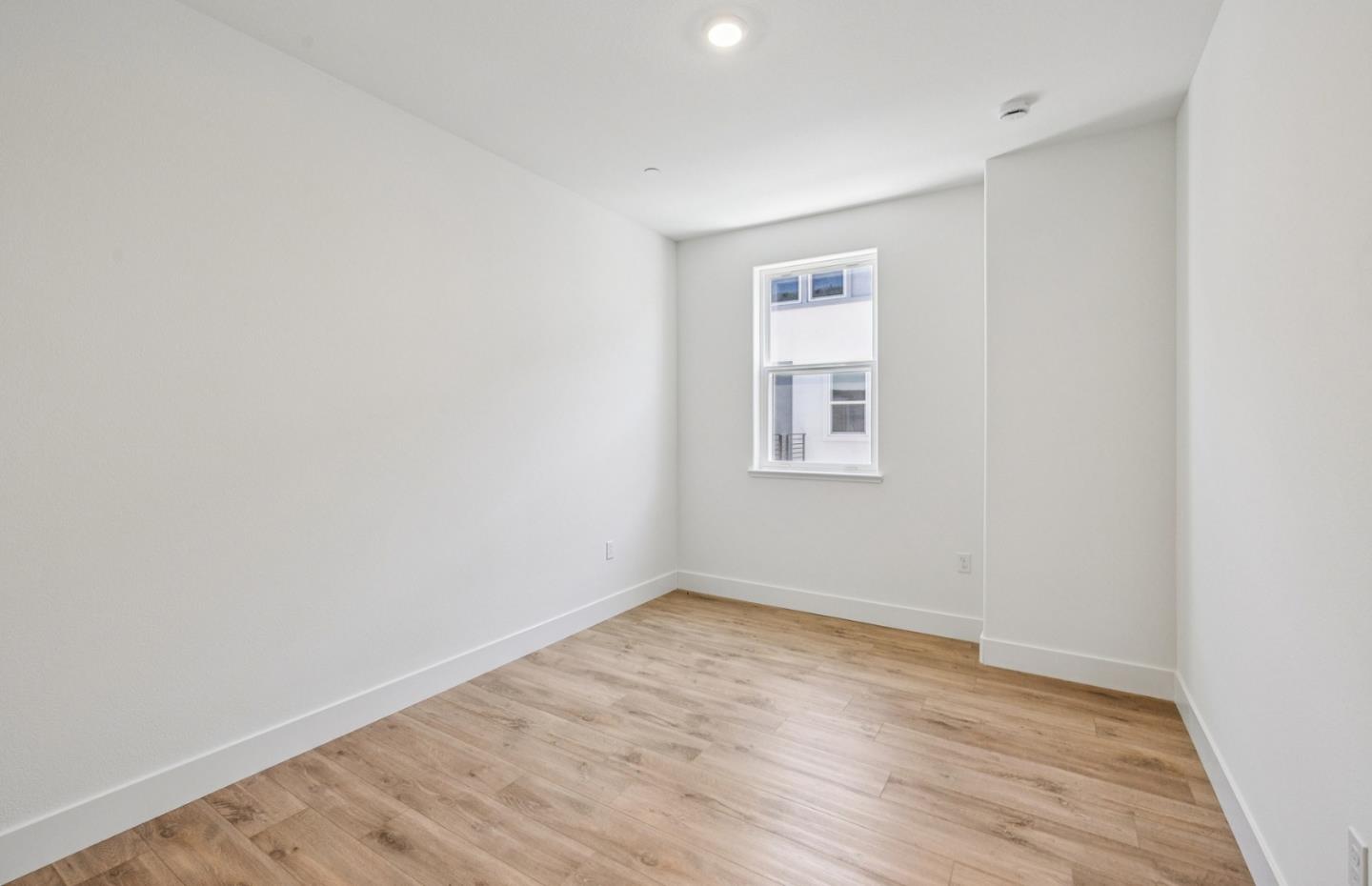 806 Redberry Way San Jose, CA 95117 - Photo 12 of 49 an empty room with wooden floor and windows