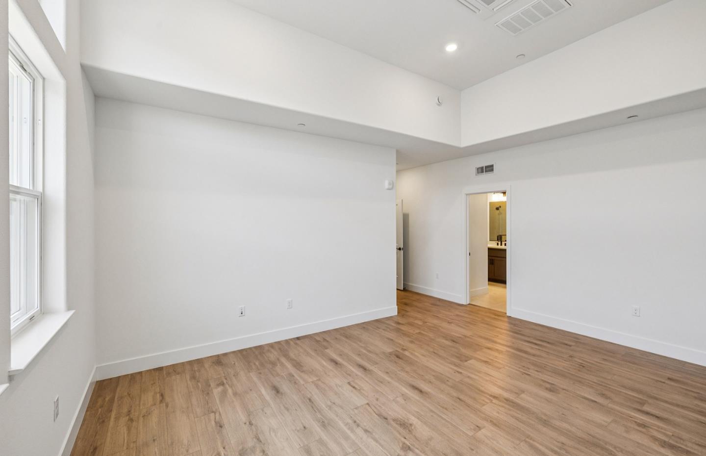 806 Redberry Way San Jose, CA 95117 - Photo 29 of 49 an empty room with wooden floor and windows