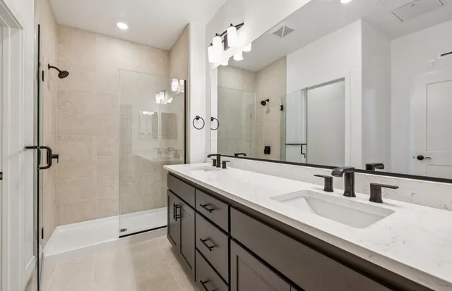 a bathroom with a sink double vanity and a mirror