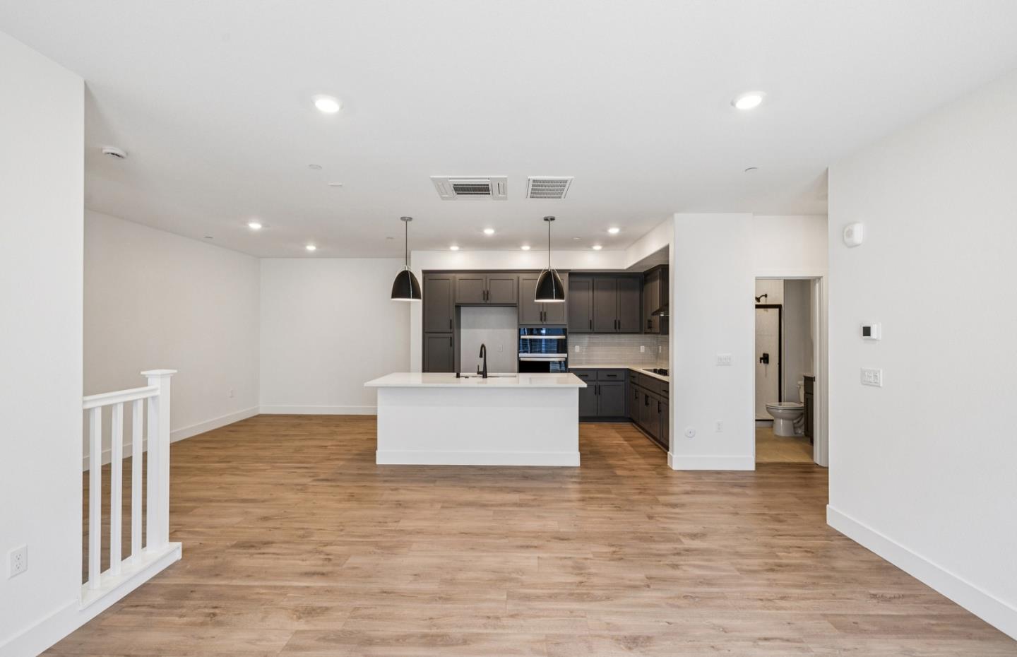 806 Redberry Way San Jose, CA 95117 - Photo 41 of 49 a view of a kitchen with kitchen island stainless steel appliances wooden floor and living room view