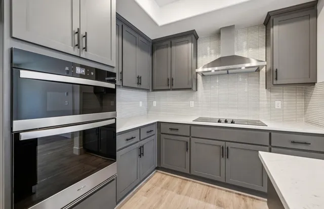 a kitchen with a sink cabinets and wooden floor