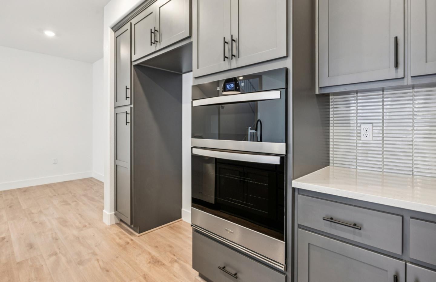 806 Redberry Way San Jose, CA 95117 - Photo 48 of 49 a kitchen with stainless steel appliances white cabinets and a wooden floor