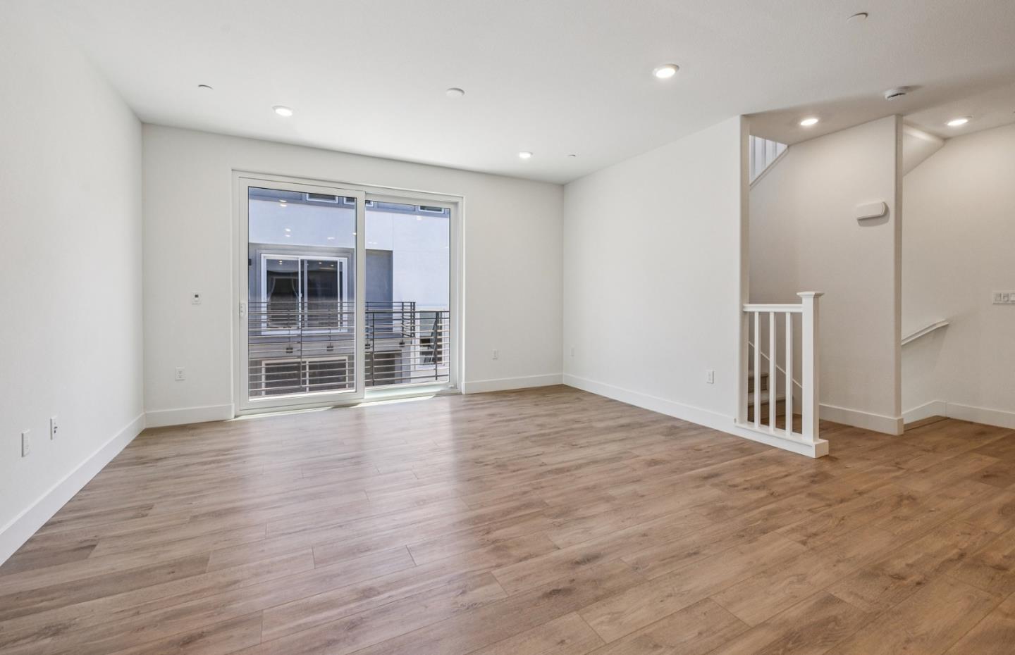 806 Redberry Way San Jose, CA 95117 - Photo 49 of 49 a view of empty room with wooden floor and windows