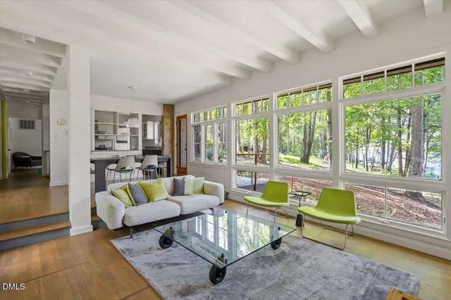 a view of a livingroom with workspace and a window