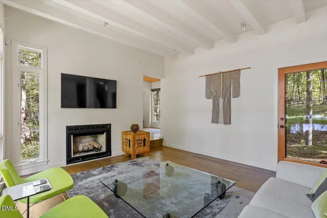 a view of a livingroom with workspace and a window